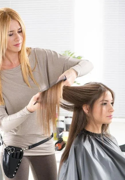Stylist applying luxury hair extensions in Delray Beach FL salon, hair transformation