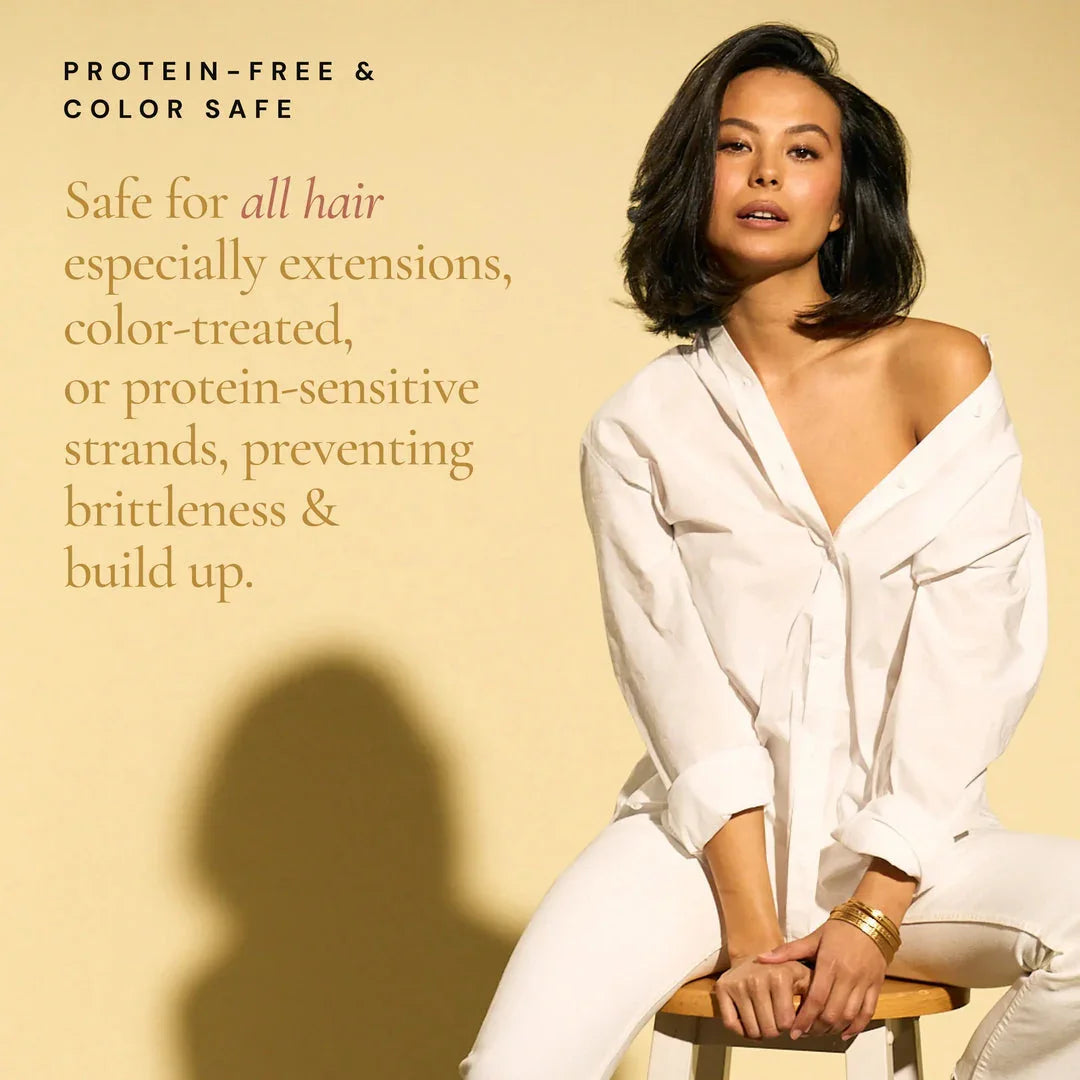 Woman with healthy hair wearing white shirt, promoting protein-free color safe hair care for extensions in Delray Beach FL.