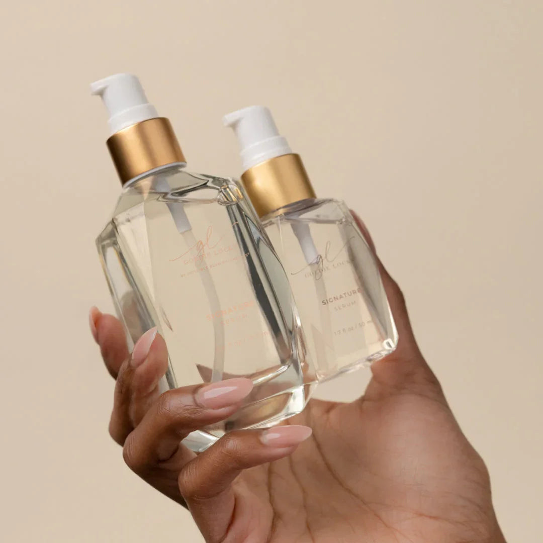 Hand holding luxury hair serum bottles for hair extensions in Delray Beach FL, Signature Extensions.