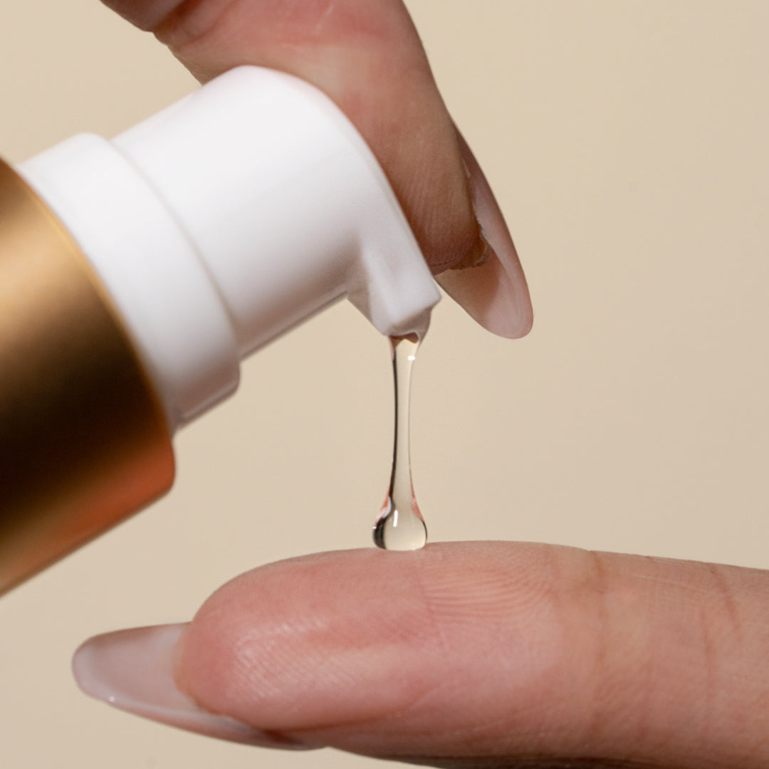 Clear hair serum dispensed onto finger for hair extensions care in Delray Beach FL studio