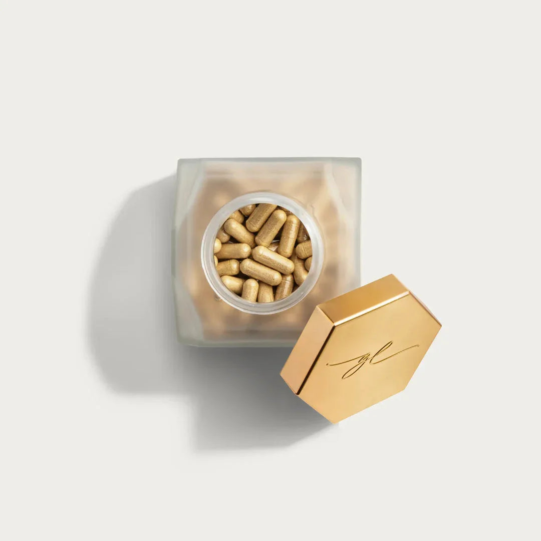 Gold-capped supplement jar with hair care capsules, luxury Delray Beach FL hair extension studio